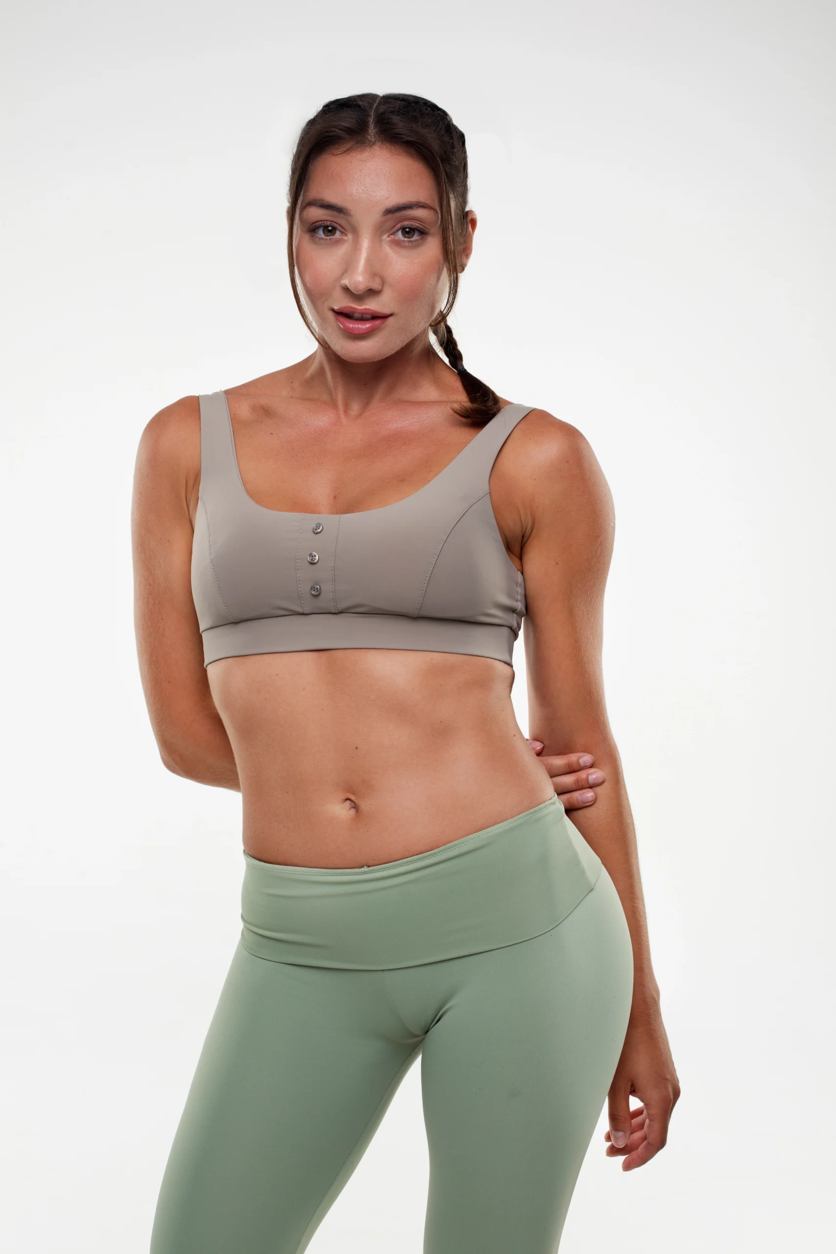 a woman flexing her body with a flat stomach